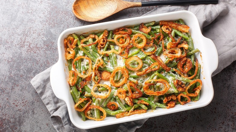 Top-down view of green bean casserole in a white, rectangular casserole dish