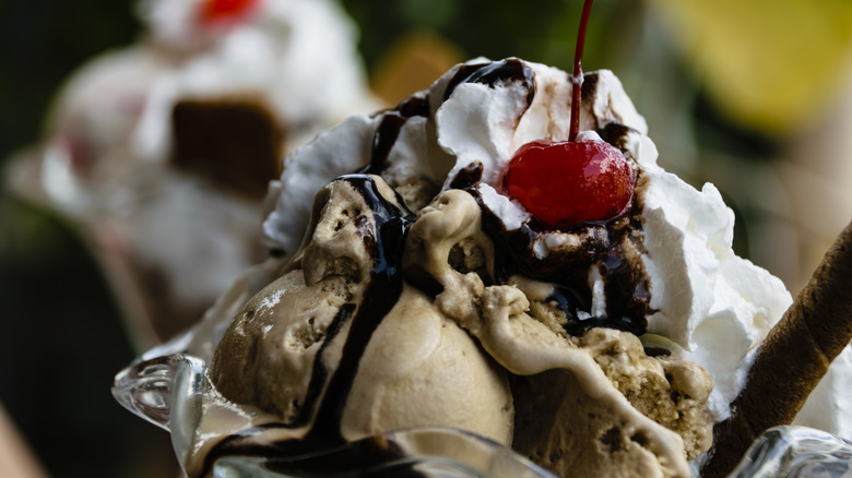 Ice cream sundae in glass dish with cherry