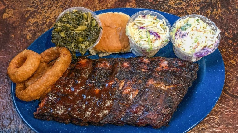 A plate of Memphis-style ribs with various sides.
