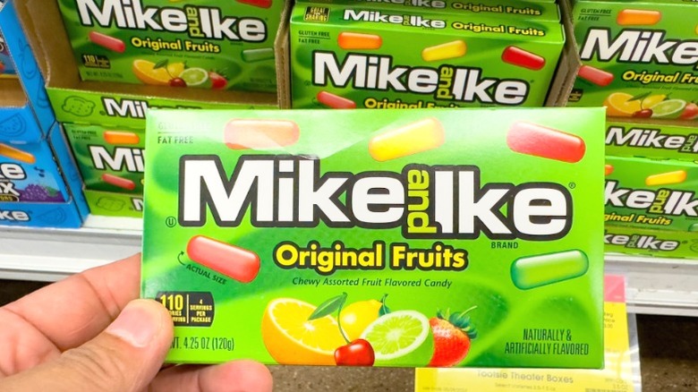 A box of Mike and Ike's being held to the camera.