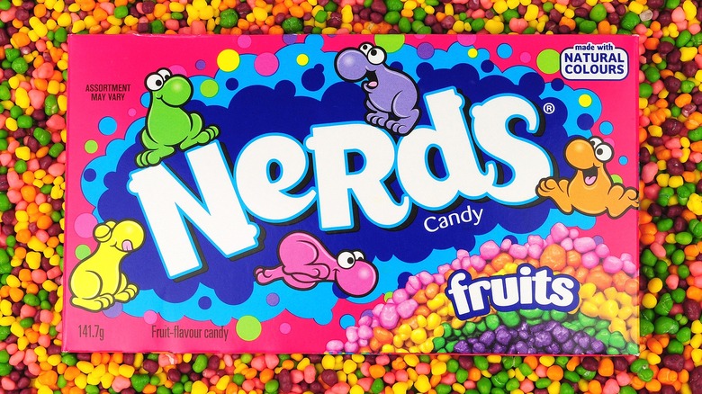 Box of rainbow Nerds candy surrounded by loose Nerds