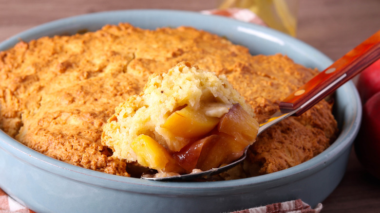 Peach cobbler getting scooped out
