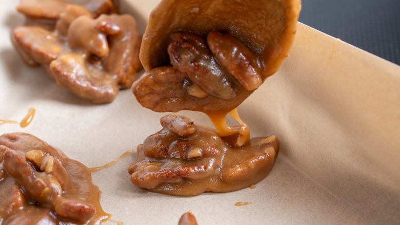 pecan pralines being spooned on parchment