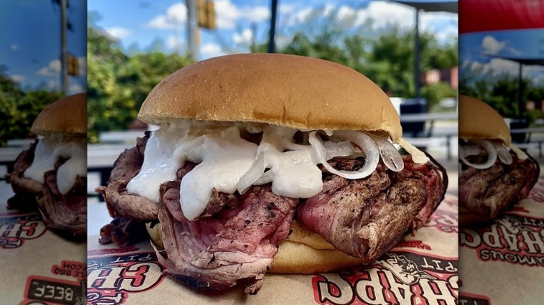 pit beef sandwich with tiger sauce and onions on a paper wrapper from Chap's Pit Beef