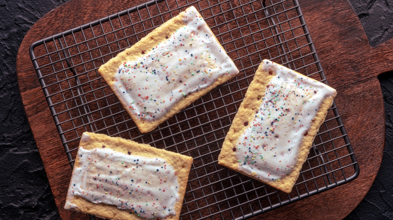 Three frosted Pop-Tarts on wire cooling rack.