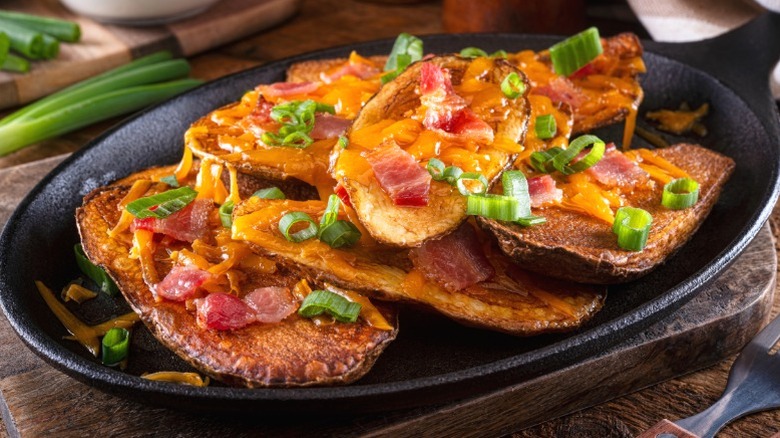 Homemade potato skins with cheese, bacon, and scallions.