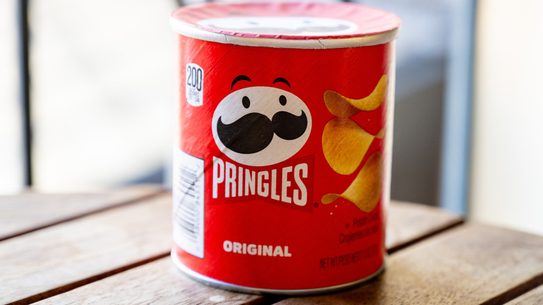Small container of Pringles potato crisps on table.