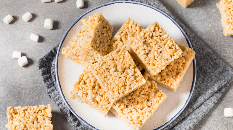 Plate of Rice Krispies treats with mini marshmallows on the side
