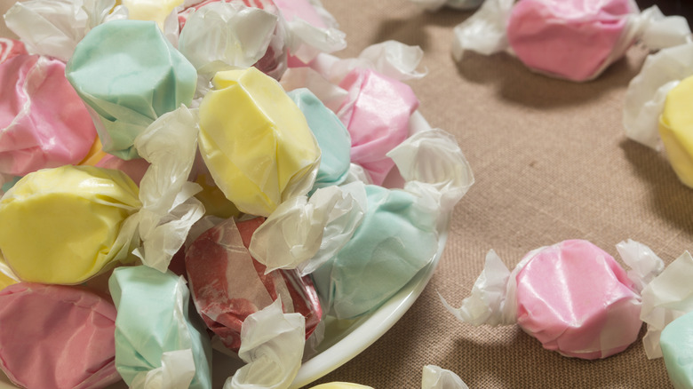 wrapped pieces of saltwater taffy in a candy bowl