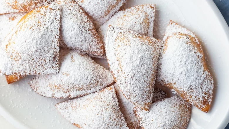 sopaipillas with powdered sugar on plate