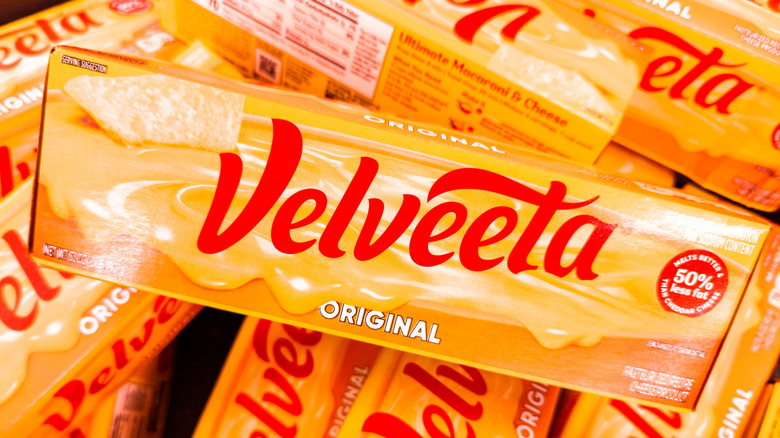 Boxes of Velveeta cheese stacked on top of each other.