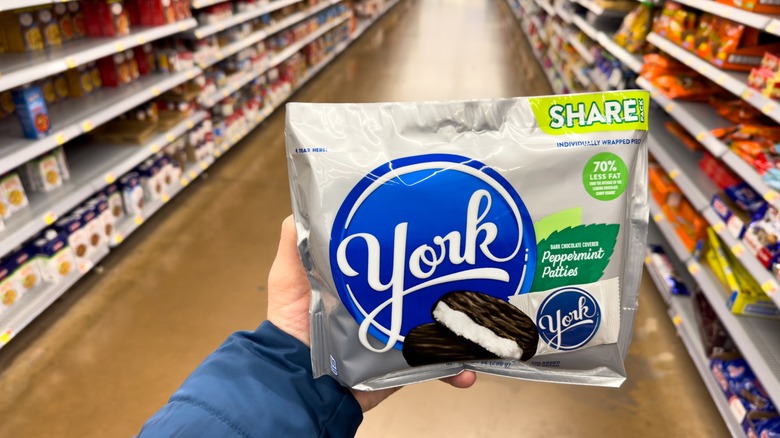 a hand holds a bag of york peppermint patties