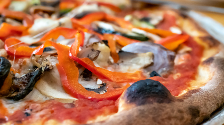 Pizza topped with hot pepper and olives