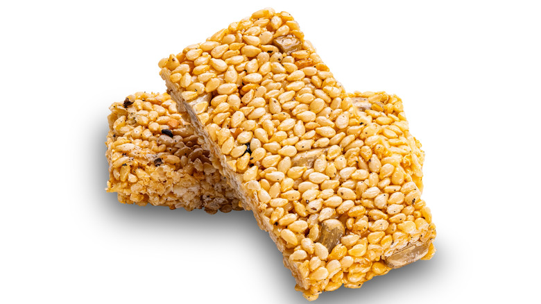 Honey and sesame seeds energy bar against a white background