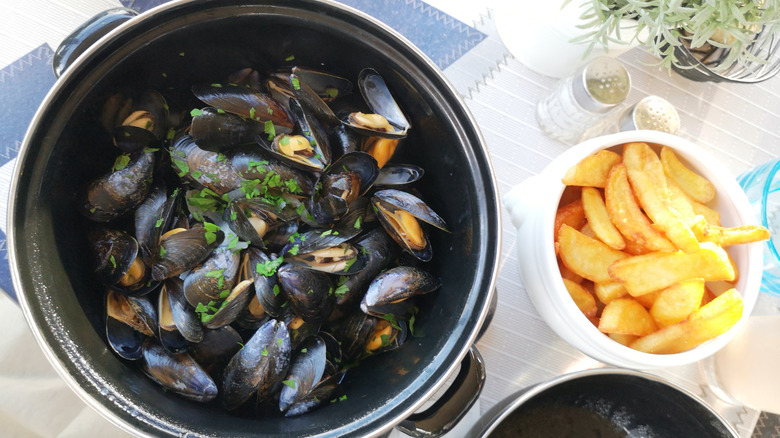 A pot of mussels and fries