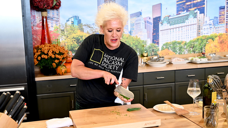 Anne Burrell teaching in the kitchen chopping chives