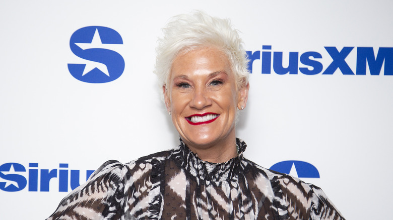 Anne Burrell smiling at an event.