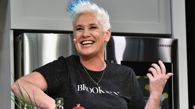 Anne Burrell smiles while filming cooking segment