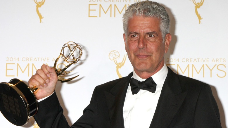 Anthony Bourdain holding Emmy award