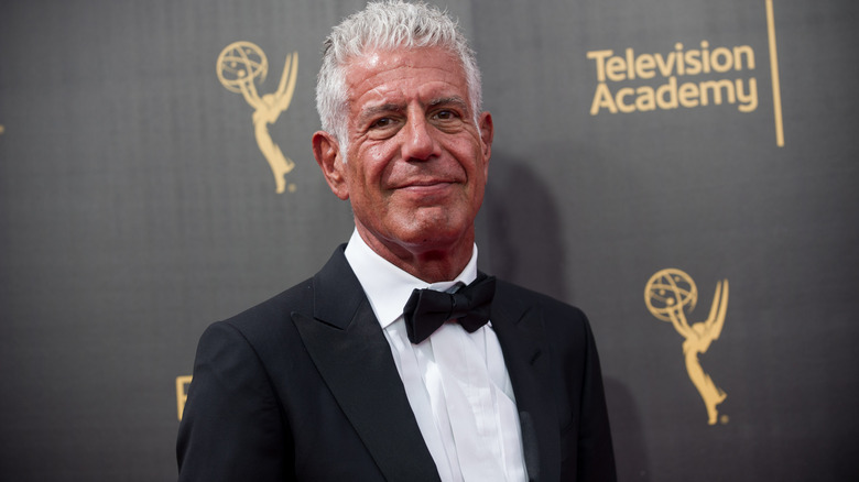 Anthony Bourdain smiling in a tuxedo at the Academy Awards Red Carpet
