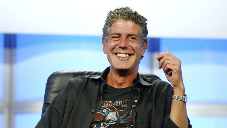 A close-up of Anthony Bourdain on stage at an event.