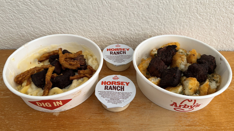 Arby's Steak 'n Mac Bowl and Steak 'n Potato Bowl two Horsey Ranch cups on a table