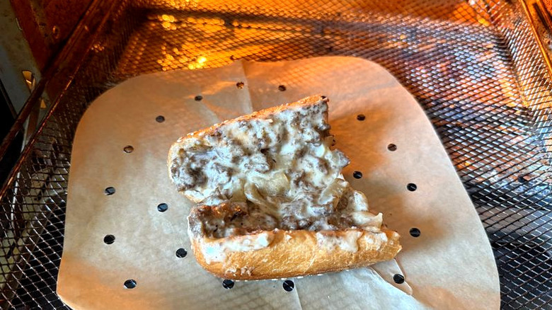 half of an Arby's cheesesteak sandwich in an air fryer