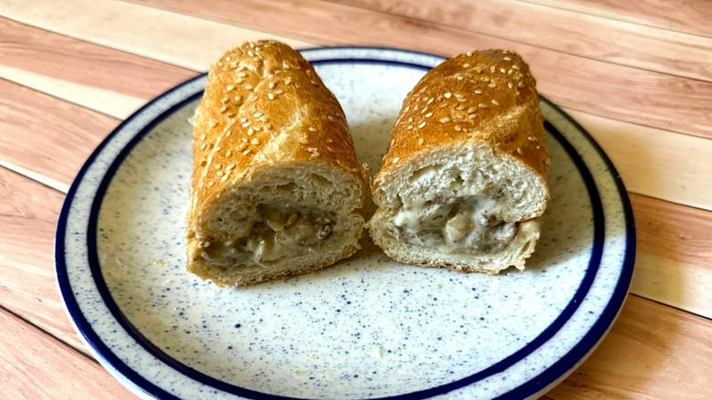 Halved cheesesteak from Arby's on a plate