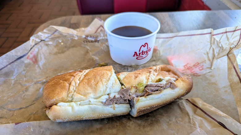 Arby's italian beef dip on table with jus