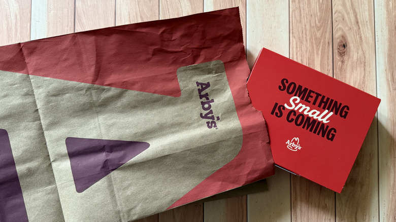 An Arby's paper bag and a box of Steak Nuggets