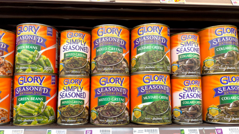 Variety of canned greens on store shelf