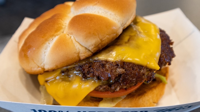A fresh Culver's ButterBurger topped with cheese, lettuce, and tomato.