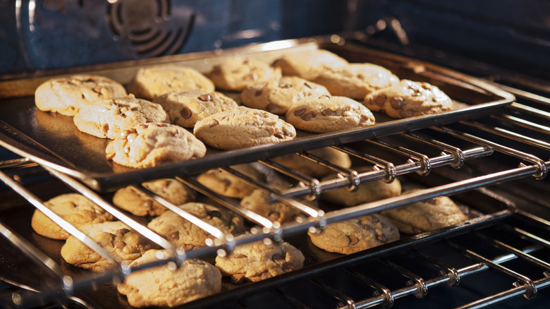 cookies baking on two pans on two racks in the oven