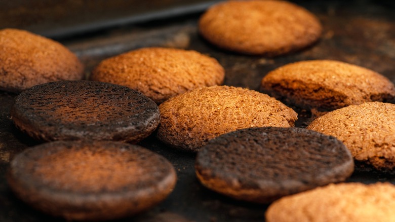 Burnt cookies on a baking sheet.