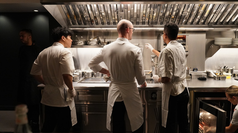 Restaurant workers in a kitchen.