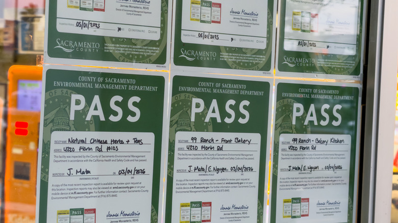 Health department certificates on display on a window in Sacramento County