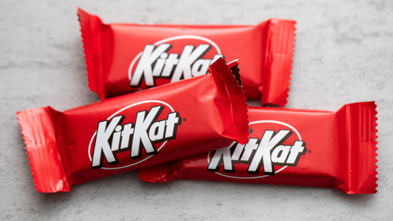 Three fun sized Kit Kat bars in their wrappers.