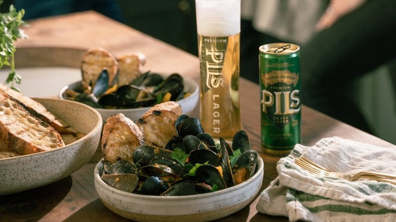 Mussels with grilled bread with can and glass of Sierra Nevada Pils in background