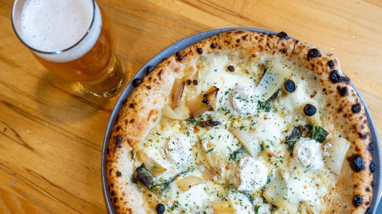 White Neapolitan-style pizza and a glass of beer