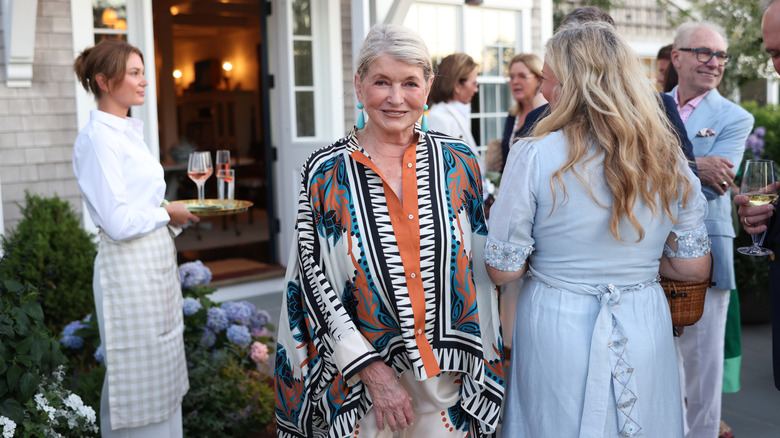 Martha Stewart smiling while at an outdoor party