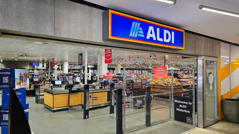 The entryway of an Australian Aldi supermarket with checkout lanes and produce visible