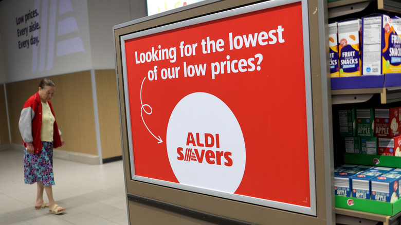 A closeup of a sign in an Aldi supermarket saying "Looking for the lowest of our low prices?"