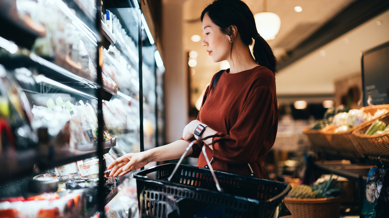 A woman shops for prepared food at a grocery store