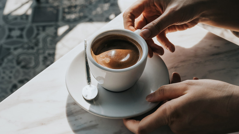 Woman holding a cup of coffee