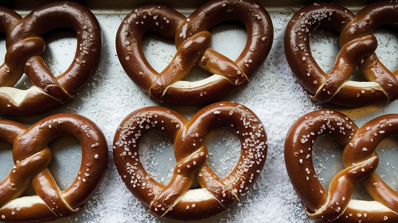 Pretzels on baking tray with sea salt