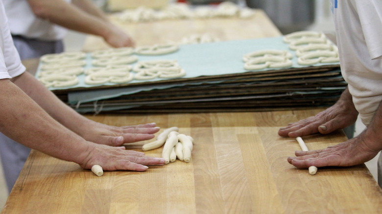 Hands kneading pretzel dough