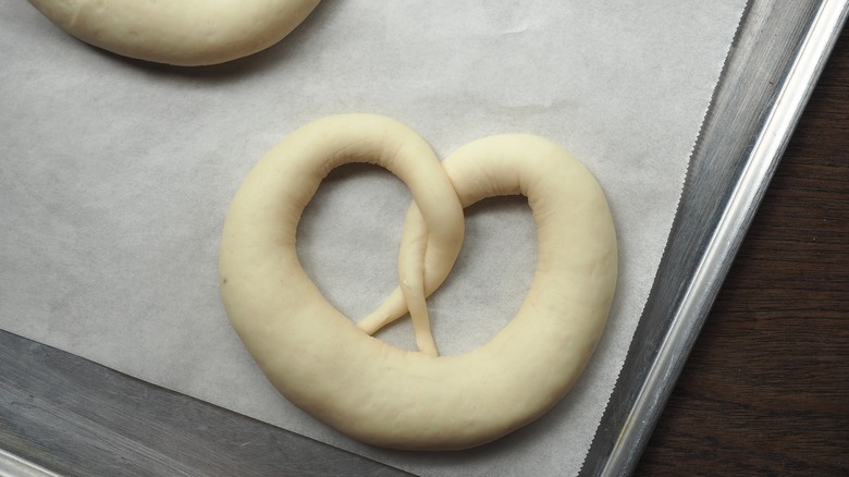Raw pretzel dough on baking tray