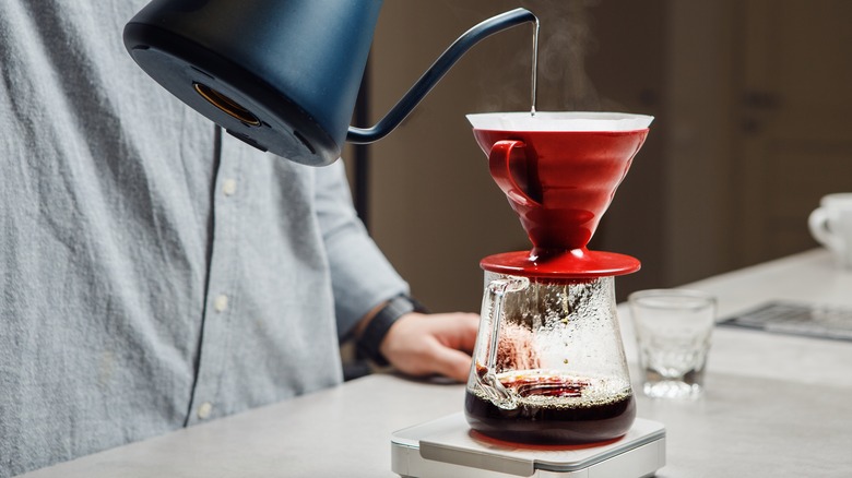 person making pour-over coffee