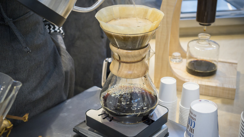 person making commercial pour-over coffee