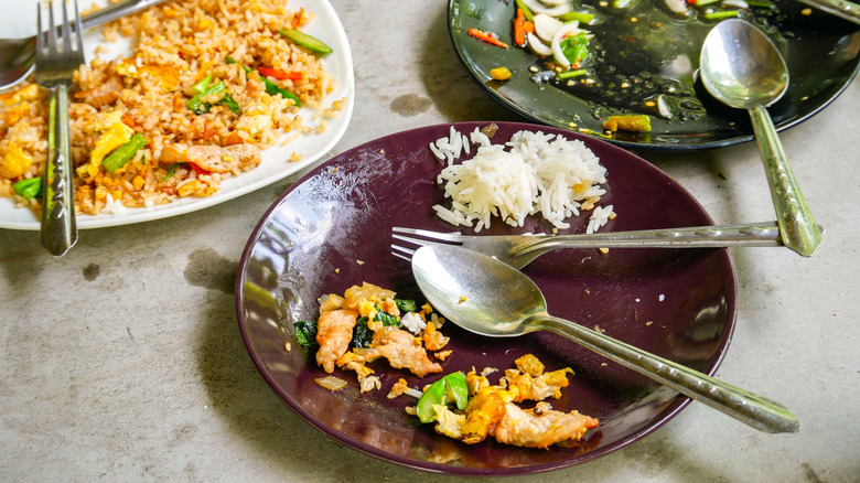 The leftover food on the restaurant table.